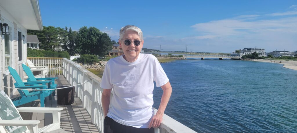 Nan Kinney standing on the deck of our guesthouse in Ogunquit, Maine, overlooking an inlet from the Atlantic Ocean.